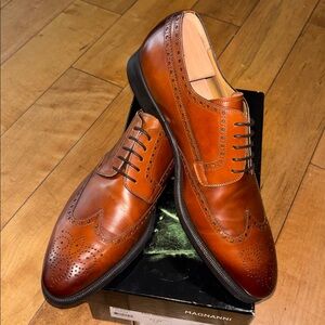 New and never worn Brown Magnanni size 12 wingtip men’s shoes.